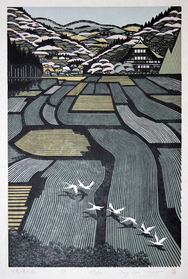 this is a japanese woodblock print depicting a rural landscape. in the foreground, we see a series of rice fields with alternating colors and patterns of lines, leading up to a village with houses and trees. the background features mountains covered in snow. a flock of birds is flying over the rice fields. the artwork has an abstract and patterned style, characteristic of japanese woodblock prints. the overall feeling is serene and artistic.