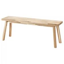 an image shows a wooden bench with a simple design, suitable for indoor use. the bench has a rectangular seat made of wooden slats and four legs that are slightly angled. the overall style is minimalist and functional.