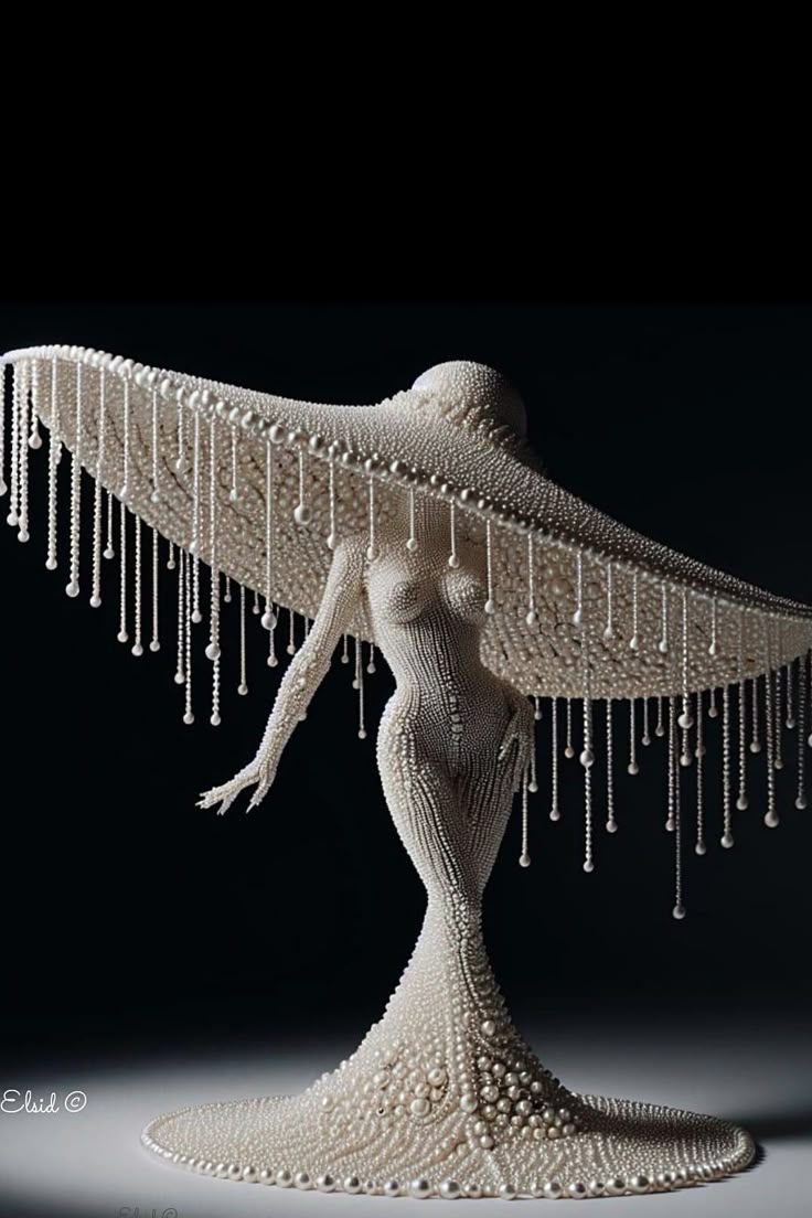 a sculpture of a woman made entirely of pearls, featuring an elegant pearl dress and a large pearl hat with beaded strands hanging from the brim. the background is black.