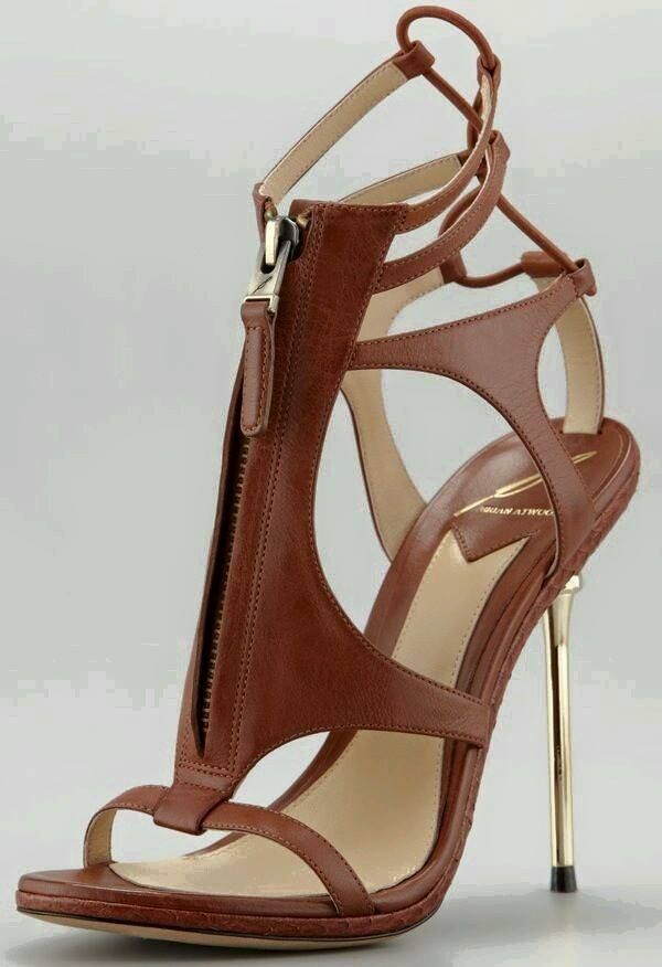 a closeup image of a pair of elegant brown leather highheeled sandals with an open toe design, a zipper detail, and an ankle strap. the shoes have a stiletto heel and a delicate, feminine silhouette.