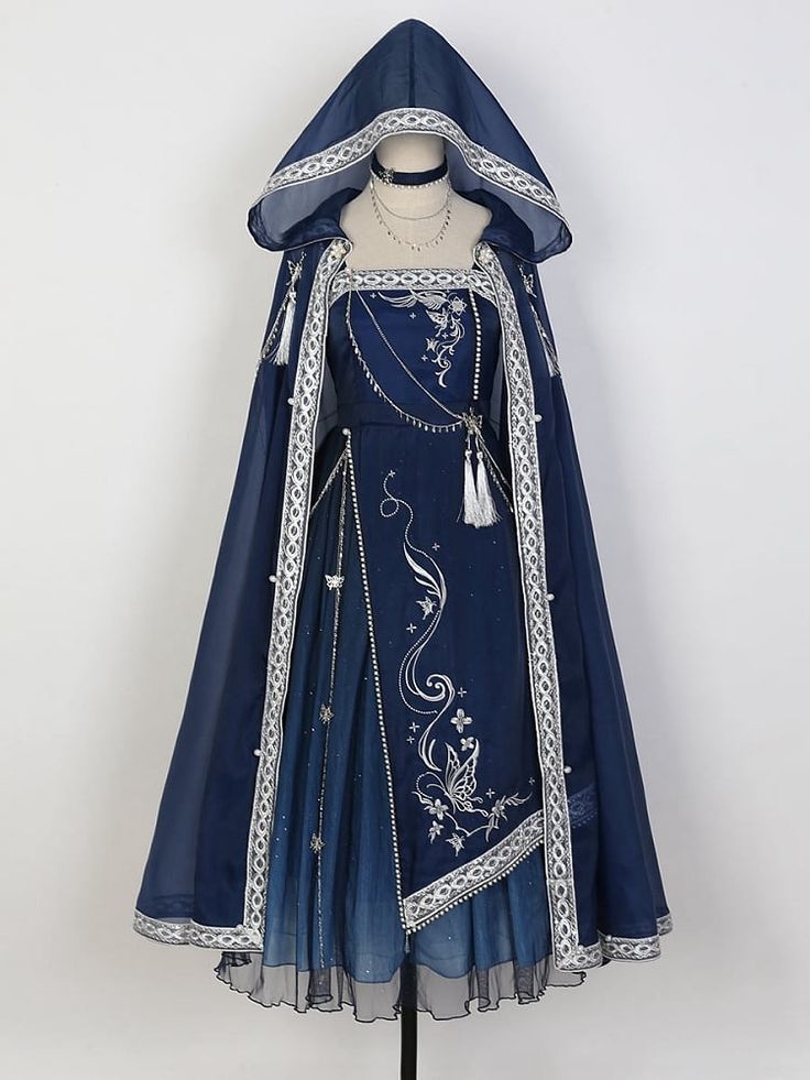 the image showcases a captivating blue lolita fashion dress. crafted from a blend of fabrics, it features intricate embroidery and a flowing silhouette. the dress includes a matching hooded cloak adorned with delicate embellishments, adding a touch of enchantment. its ethereal design embodies elements of fantasy and elegance.