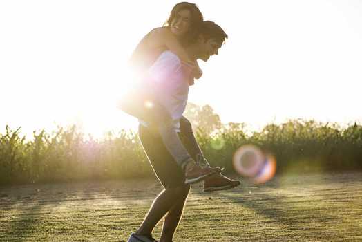 Man giving to girlfriend piggyback ride Stock Photo by ©gstockstudio  147713371