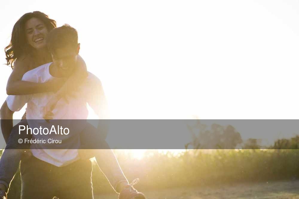 Man giving to girlfriend piggyback ride Stock Photo by ©gstockstudio  147713371