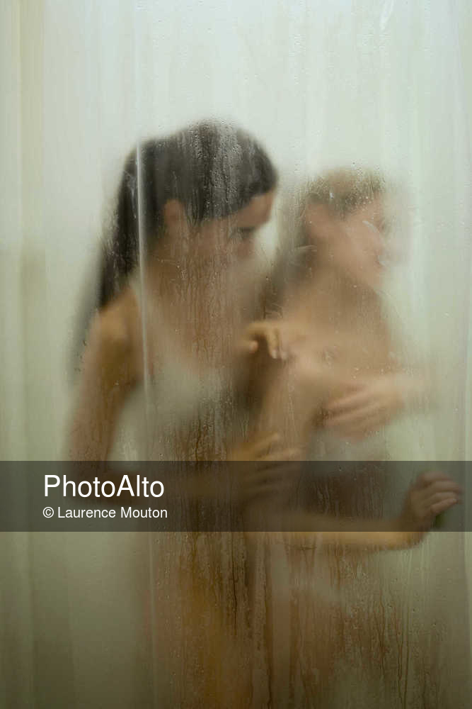 Two young women having bath in bathroom - Photoalto.