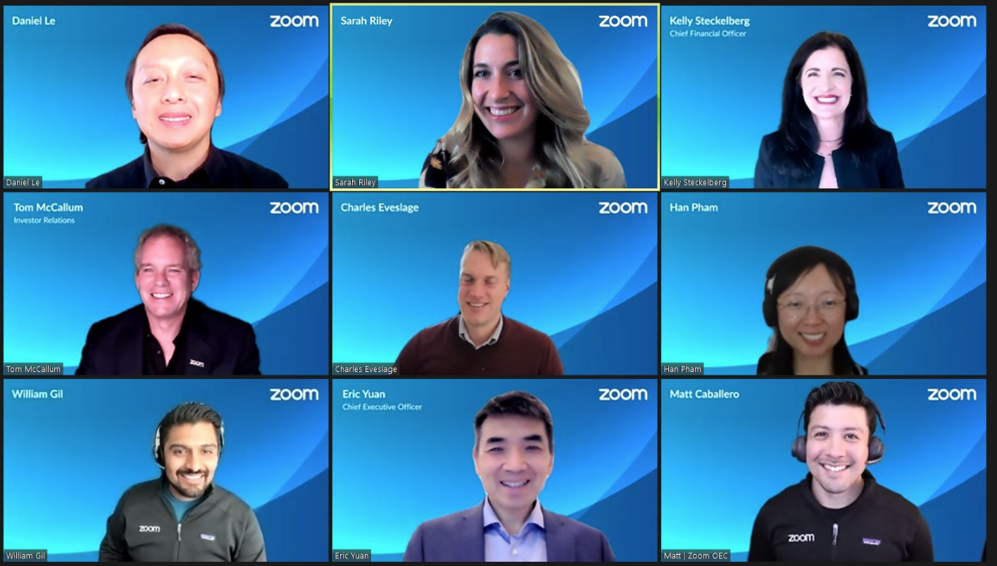 Grid of nine video conference participants with blue virtual backgrounds, showing people in professional attire