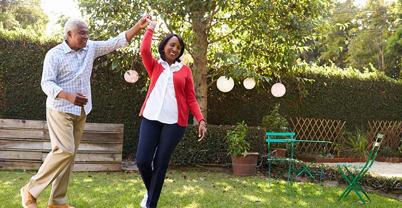 Older Black couple dancing in their backyard in Huntley Illinois