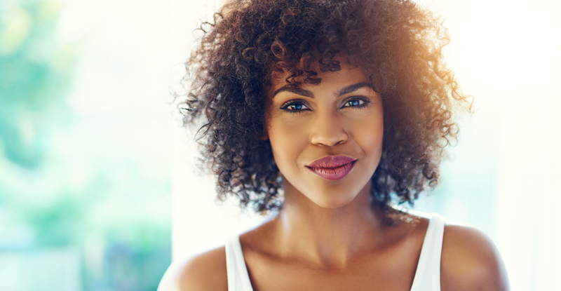 Radiant Black woman in white tank top