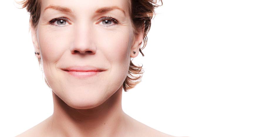 Close up of middle-aged female with fresh-looking skin and pixy hairstyle