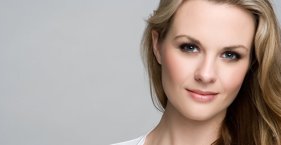 Close up of a fair-skinned blonde woman with perfectly smooth skin