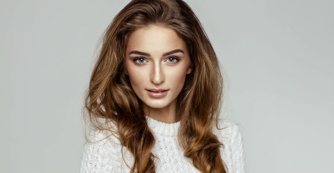 Brunette in white sweather and great skin looking right at you