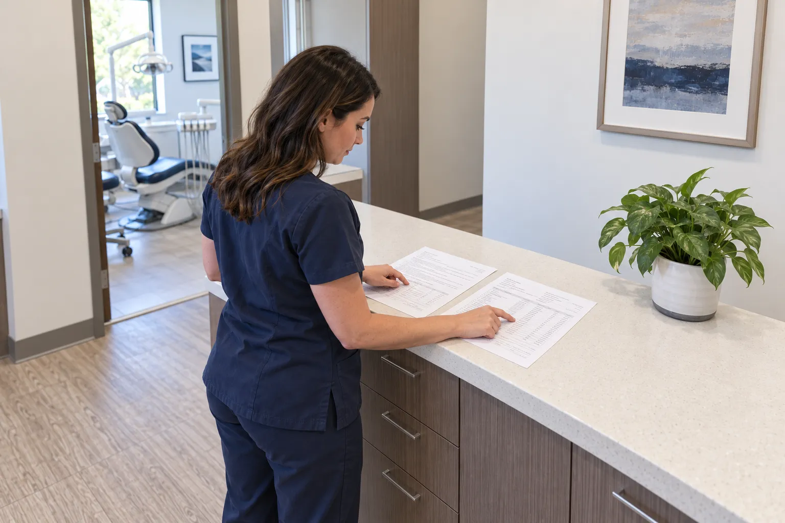 A dental billing specialist cross-checks matching rows on a provider note and a medical claim draft.