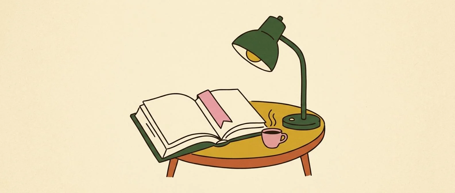 An open book, reading lamp, bookmark, and cup arranged for a quiet reading session.