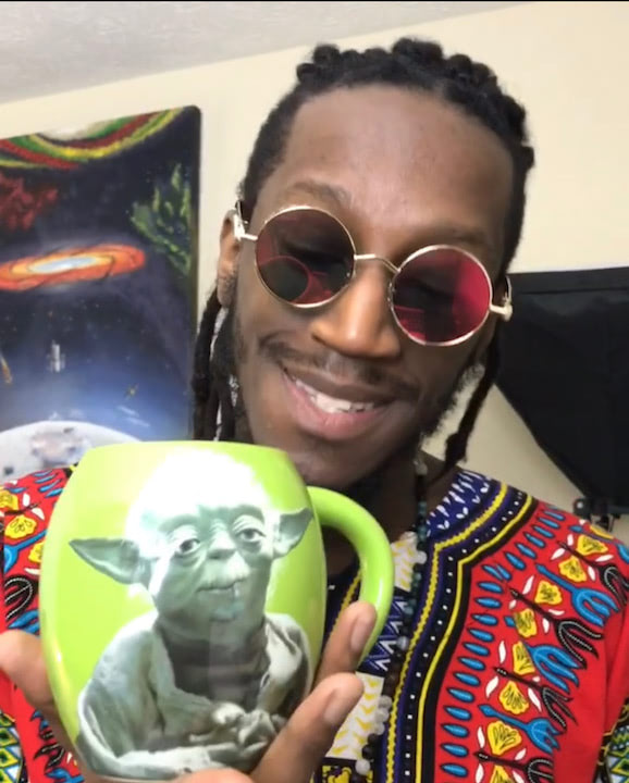 Mr. Wildenfree sips tea from his Yoda mug in a red dashiki, Feb. 22nd for February Flows