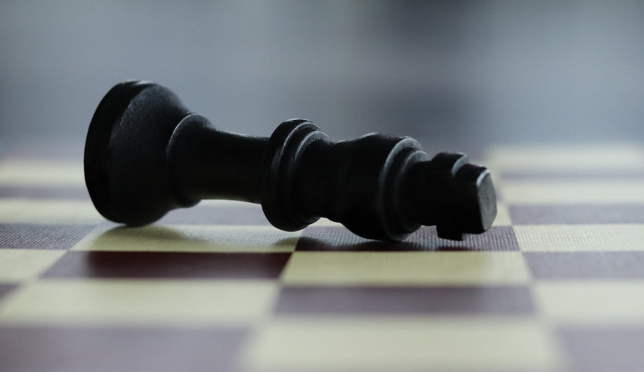 Free Chess Piece Lying on the Chessboard  Stock Photo