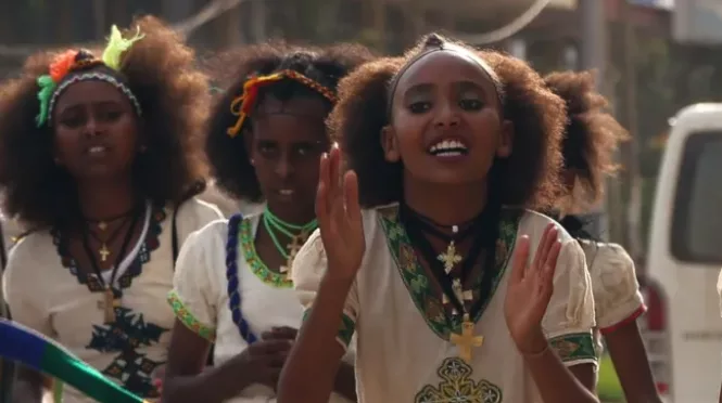 Young women dressed in traditional attire participate in the Ashenda festival in Ethiopia.
