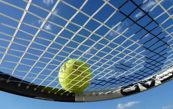 Raqueta de tenis con pelota vista desde abajo, ejemplo de artículo deportivo ligero y rígido