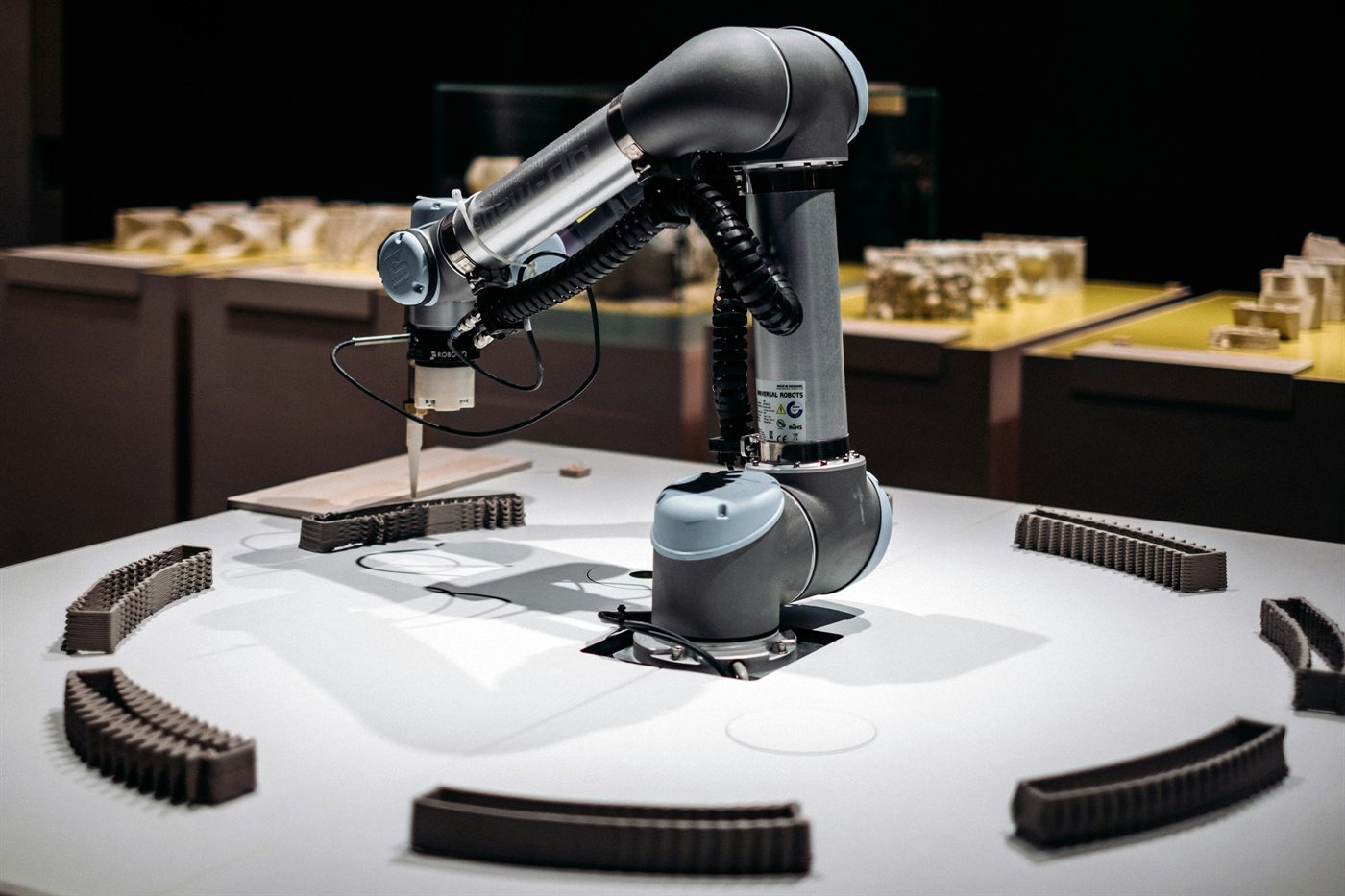 A robotic arm positioned over a laboratory workbench