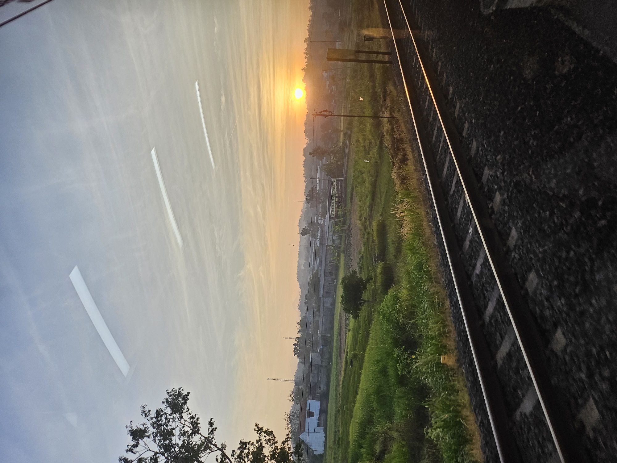 Rural train tracks at sunrise near Margosari, Indonesia