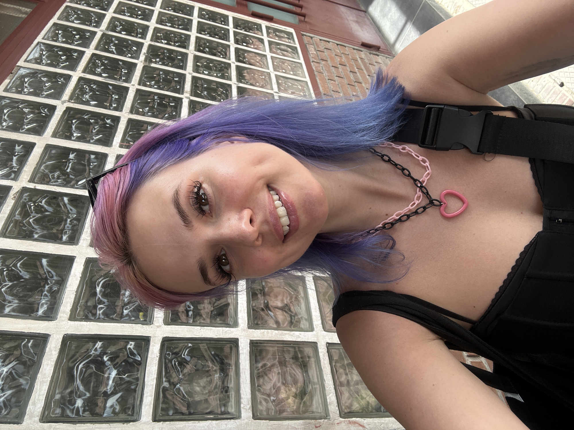 Woman with colorful hair spotted near glass wall in Madrid