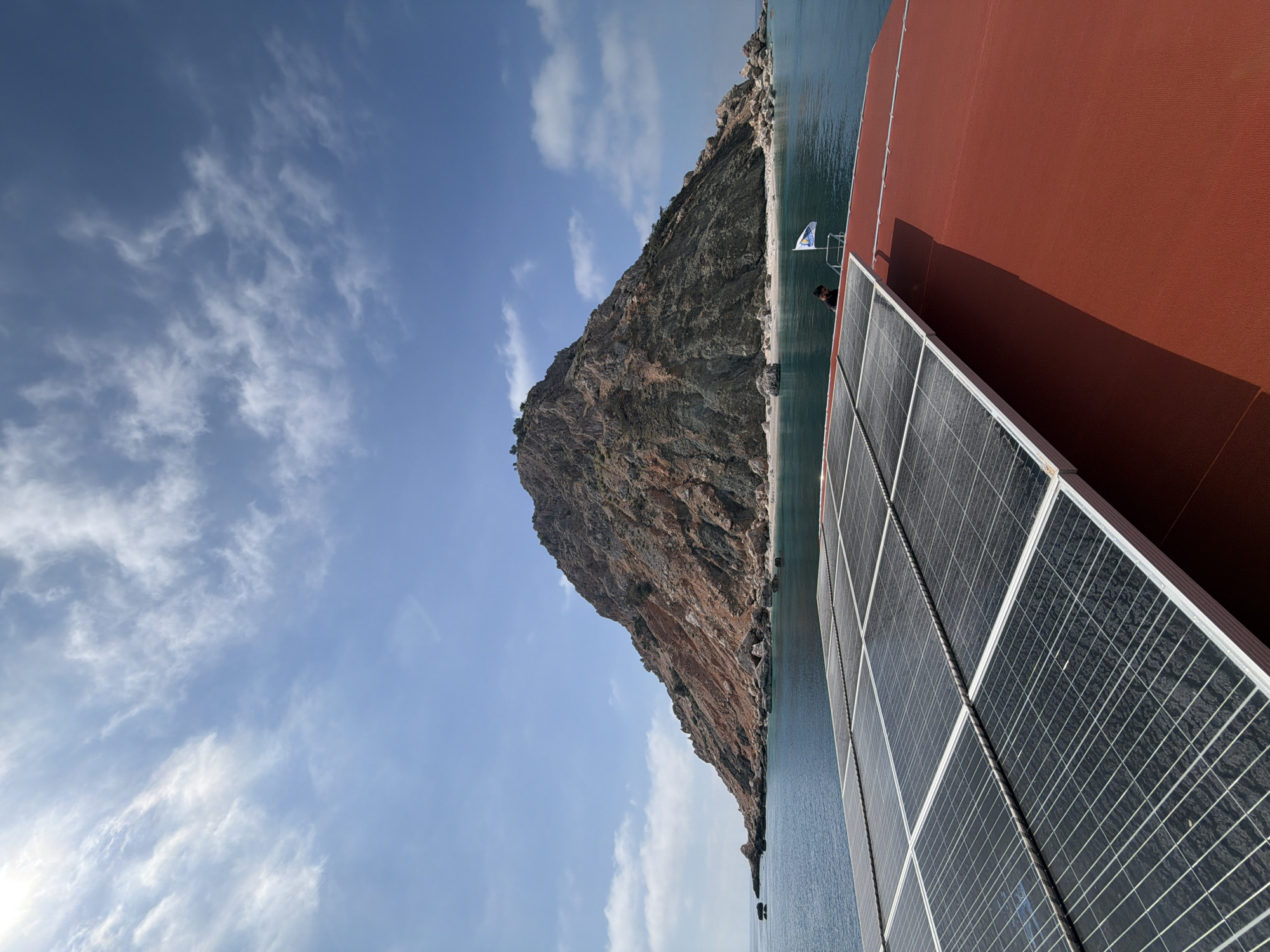 Boat passengers document scenic Turkish coastal cliffs journey