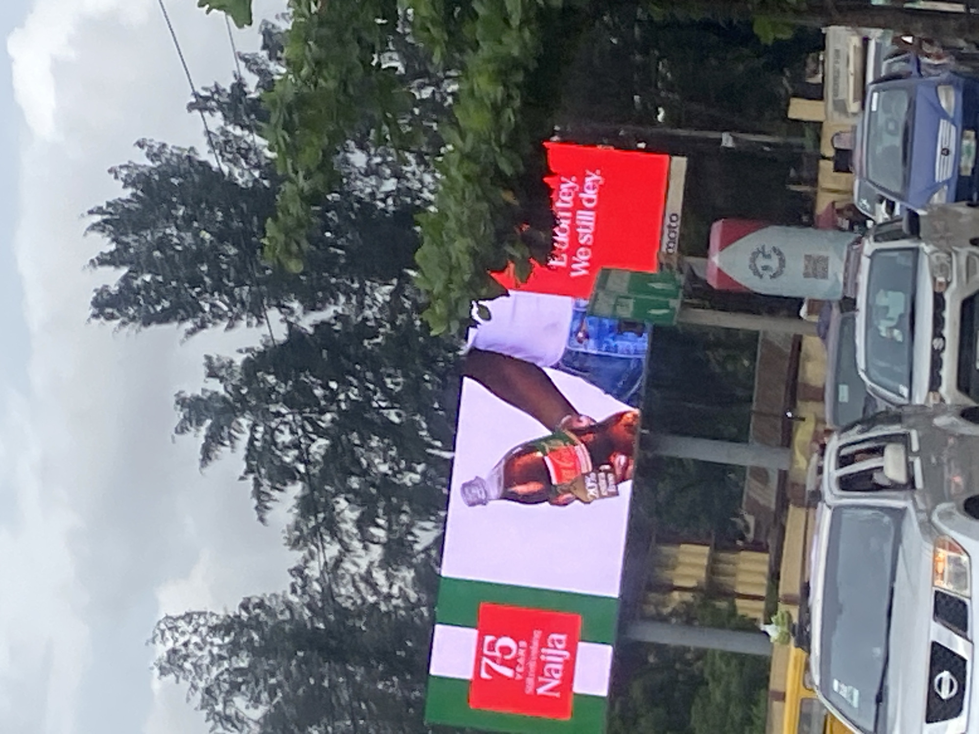 Slow traffic and billboard-lined streets in Ikeja, Lagos