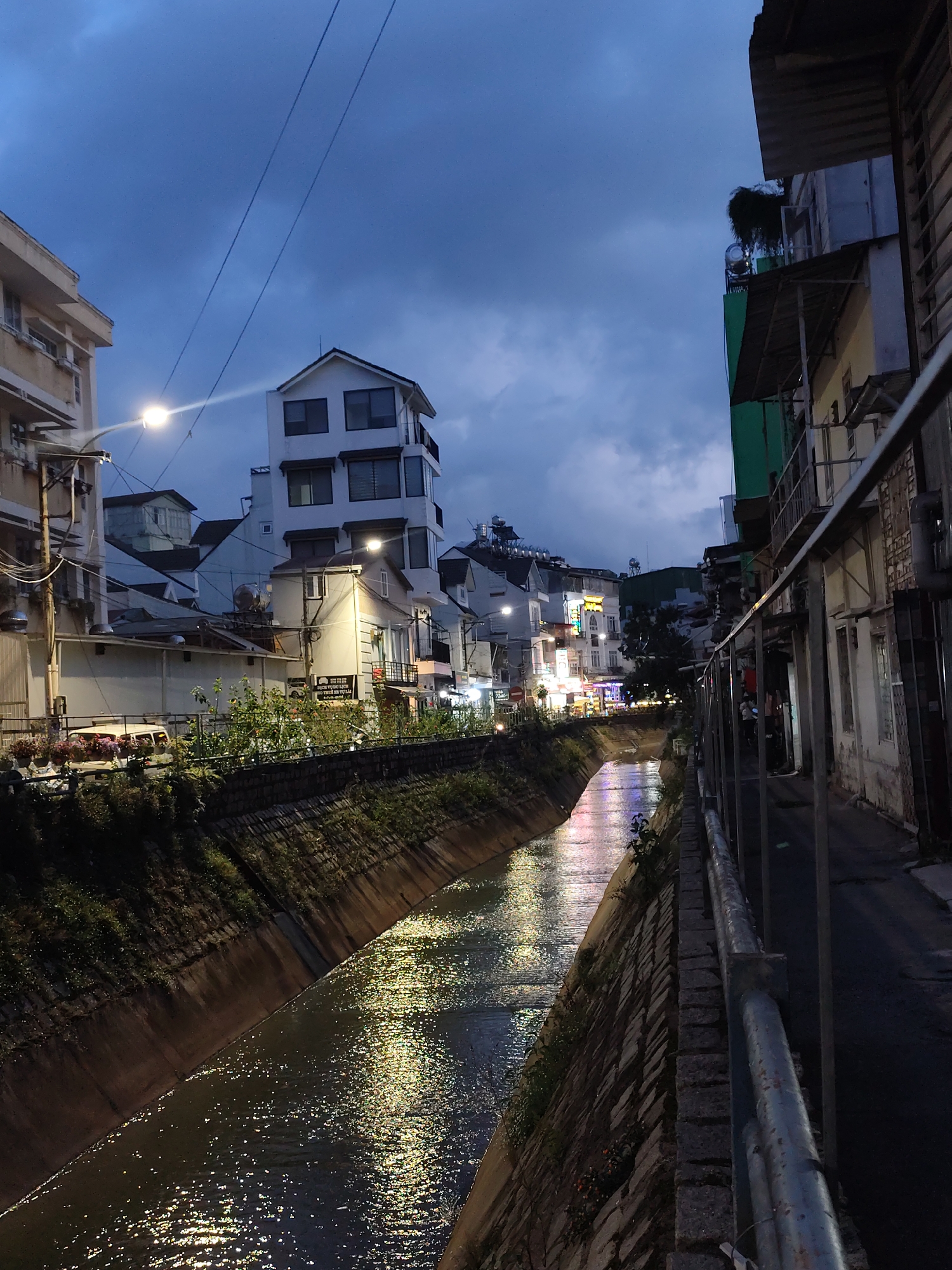 Da Lat at dusk: canals, storefronts, and street-level nightlife