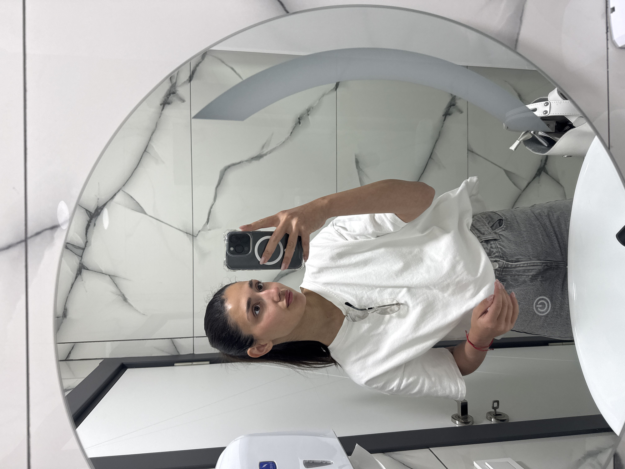 Woman takes bathroom mirror selfie in Podgorica