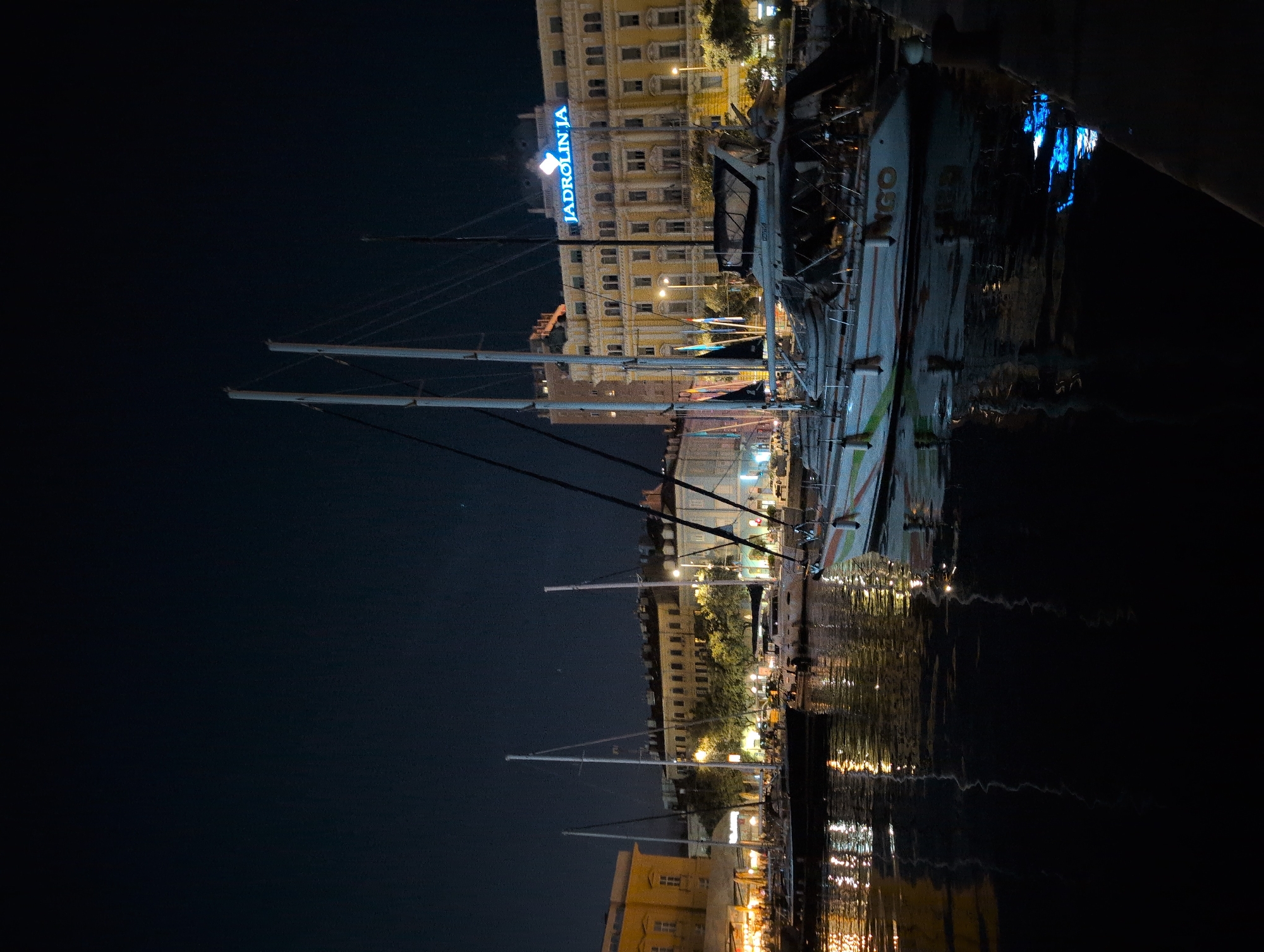Rijeka harbor at night, sailboats and cargo ships docked