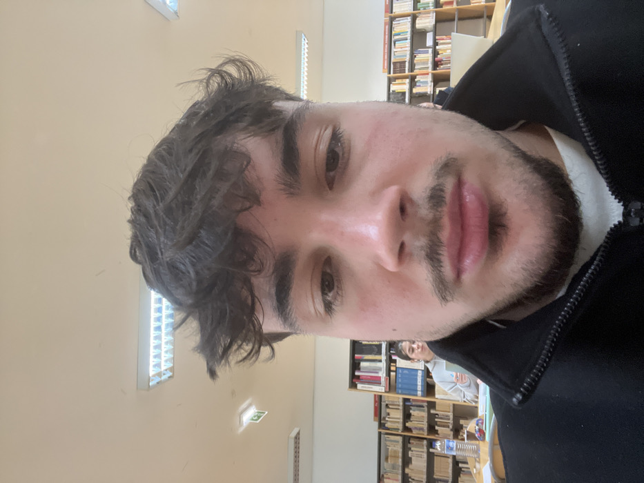 Student Takes Multiple Selfies in Bragança Library Study Session