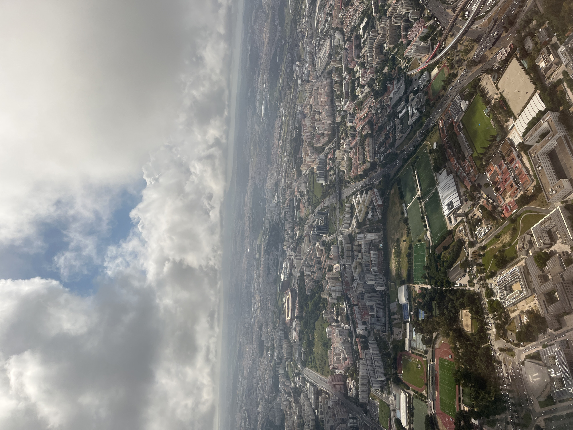 Aerial view captures Lisbon cityscape with stadium, sports facilities