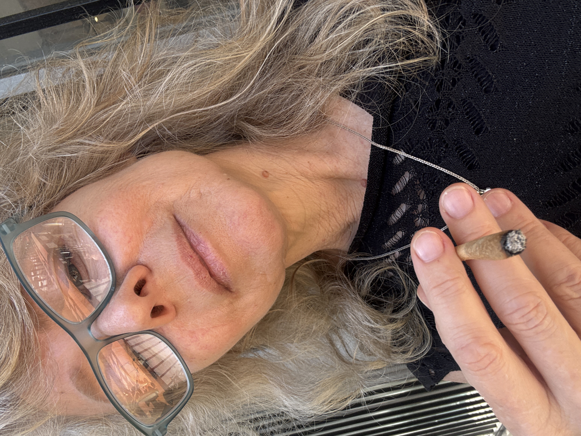 Woman smokes marijuana indoors in Tel Aviv