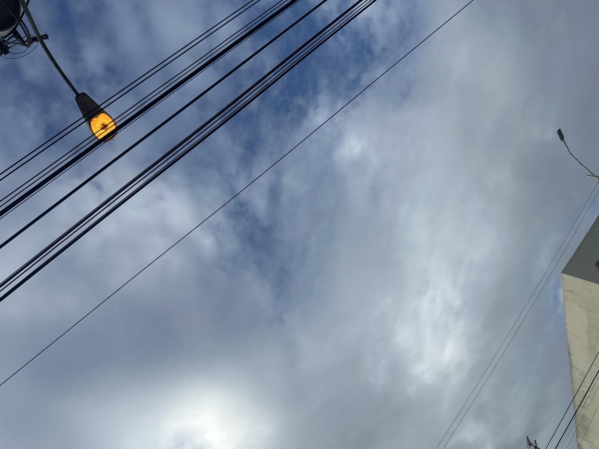 Porlamar streets under a web of overhead wires and cloudy skies