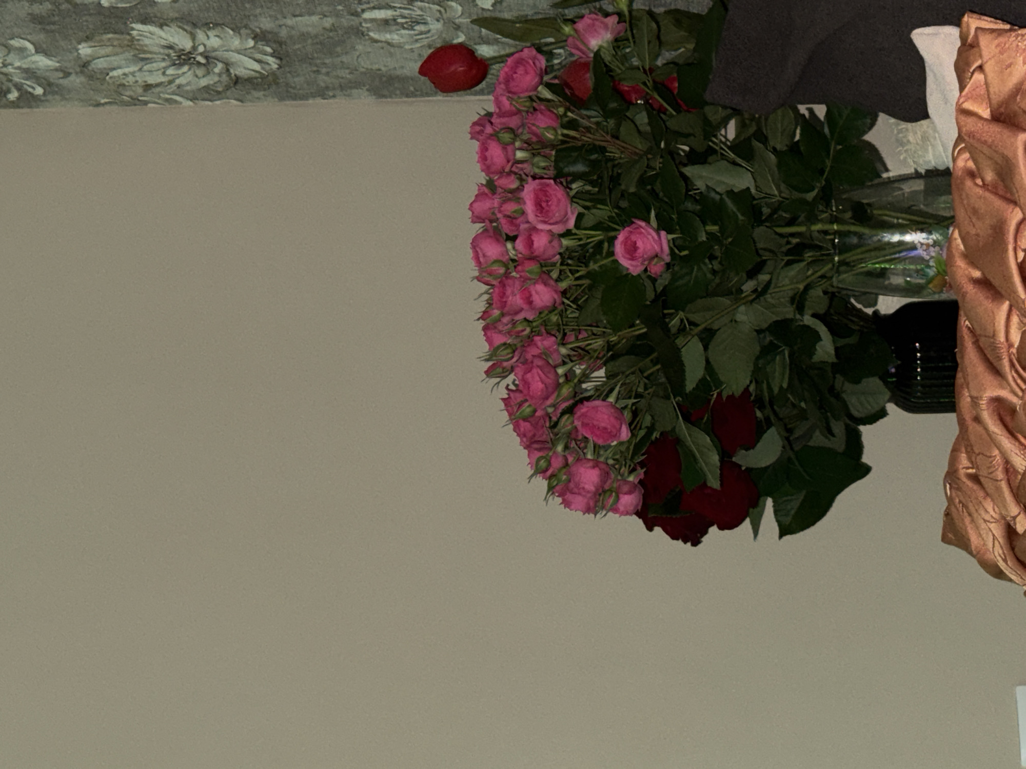 Pink and red rose arrangement observed in transparent vase