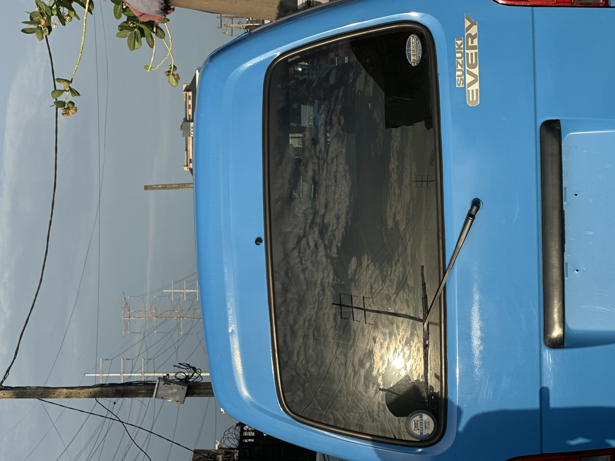 Blue van parked on street in Ilado, Nigeria