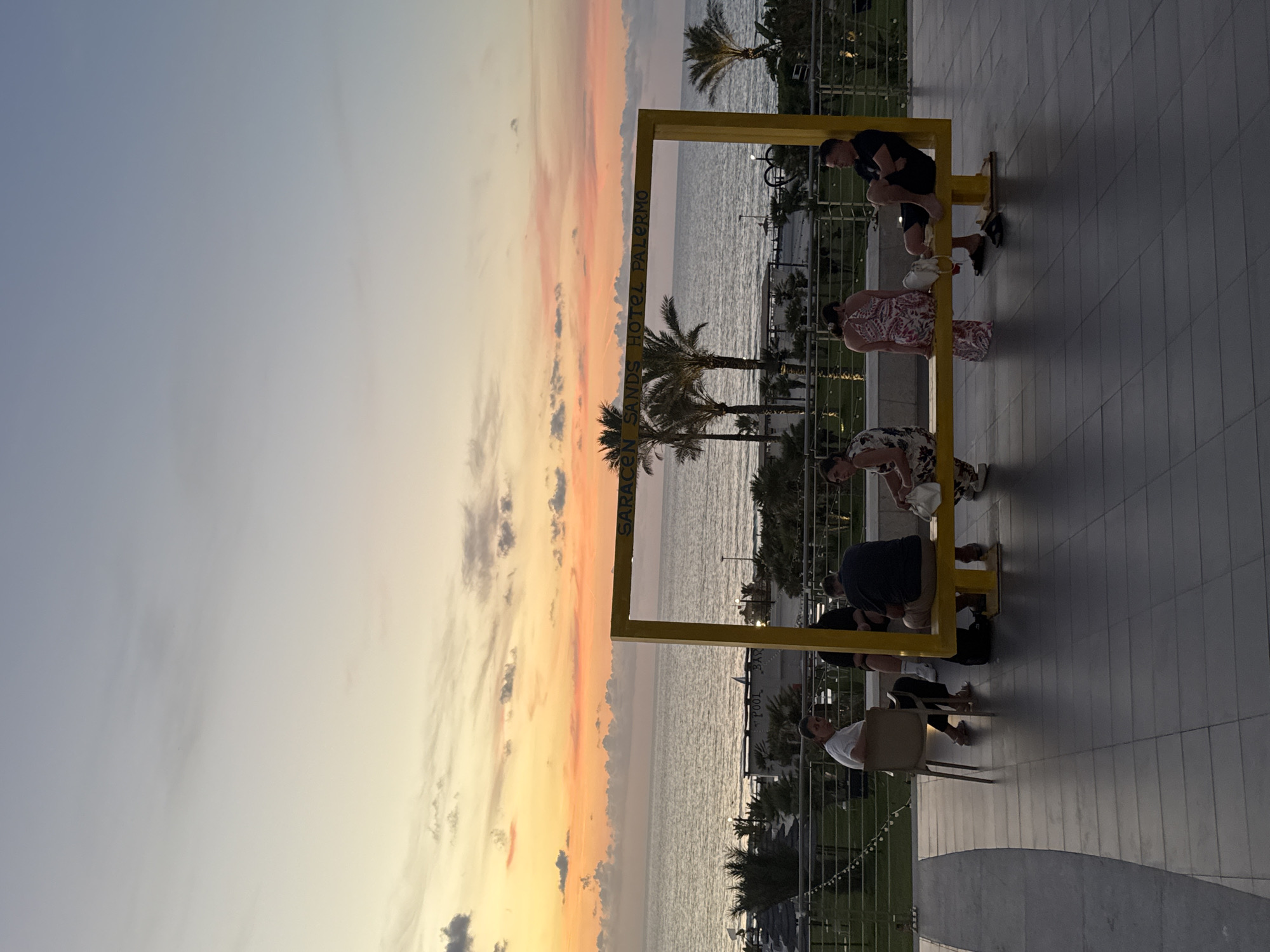 Sunset gathers at a Sicilian coastal resort's waterfront