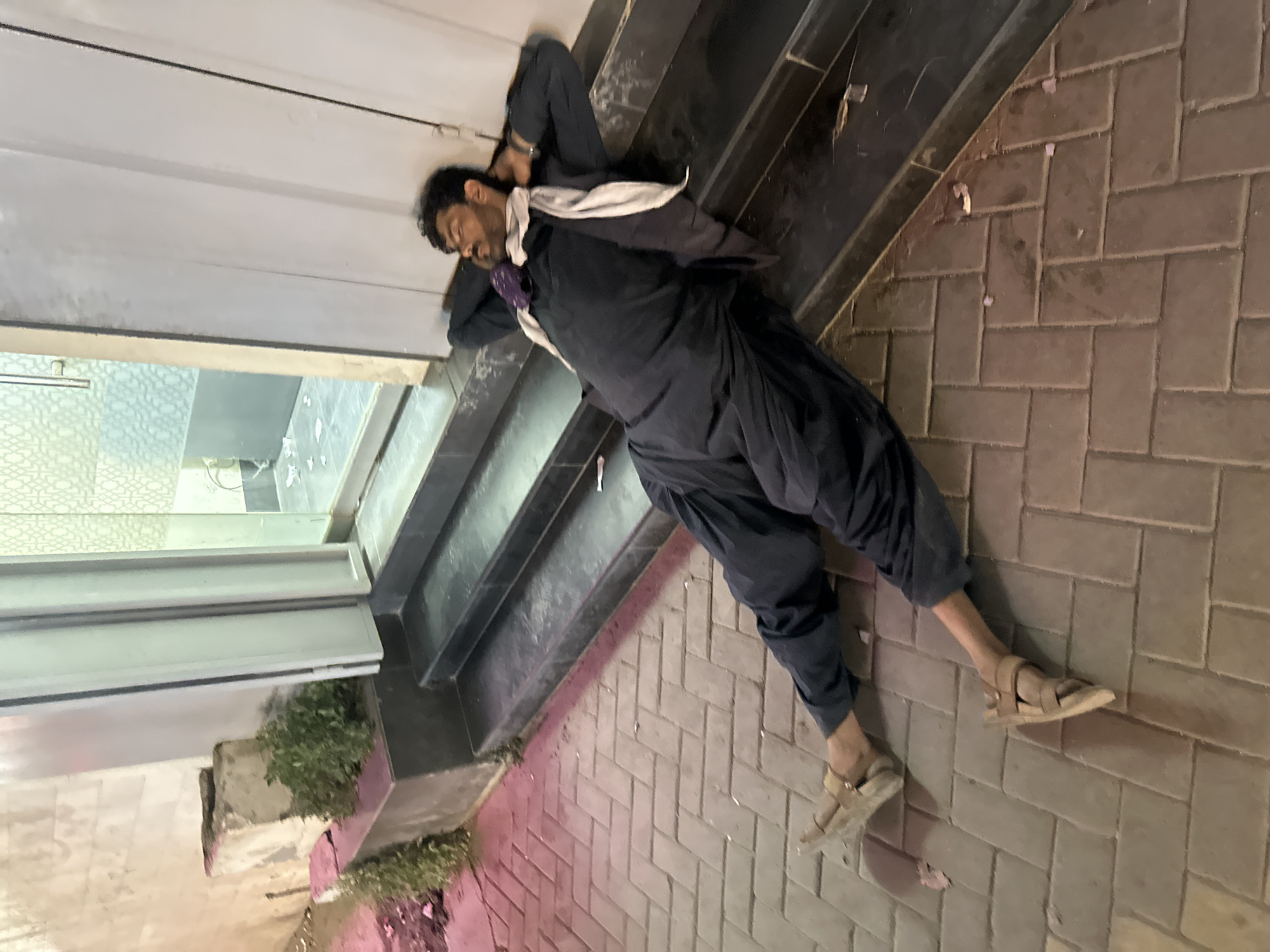 Evening scenes captured in Quetta: resting man, lit storefront