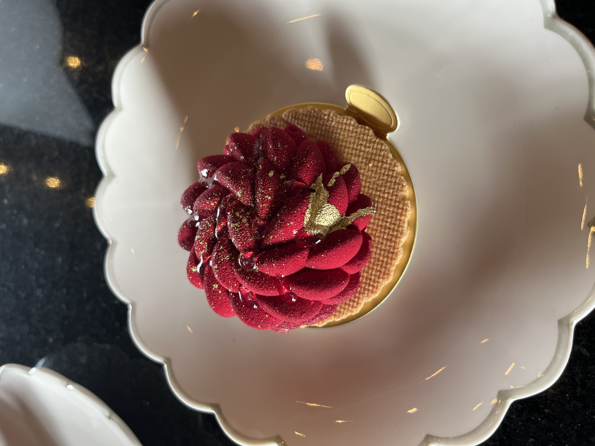 Decorated cake with red flower frosting photographed from above