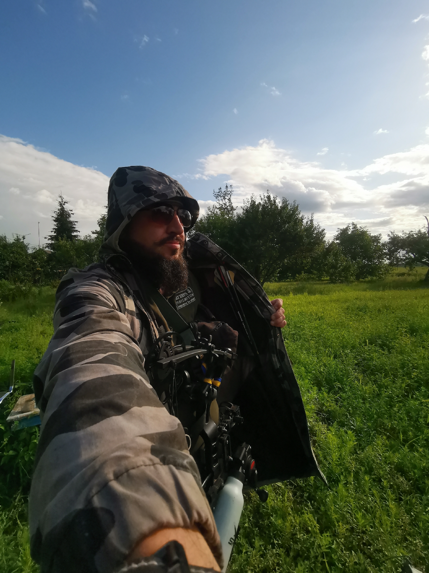 Camo gear and archery equipment on display in a Ukrainian field