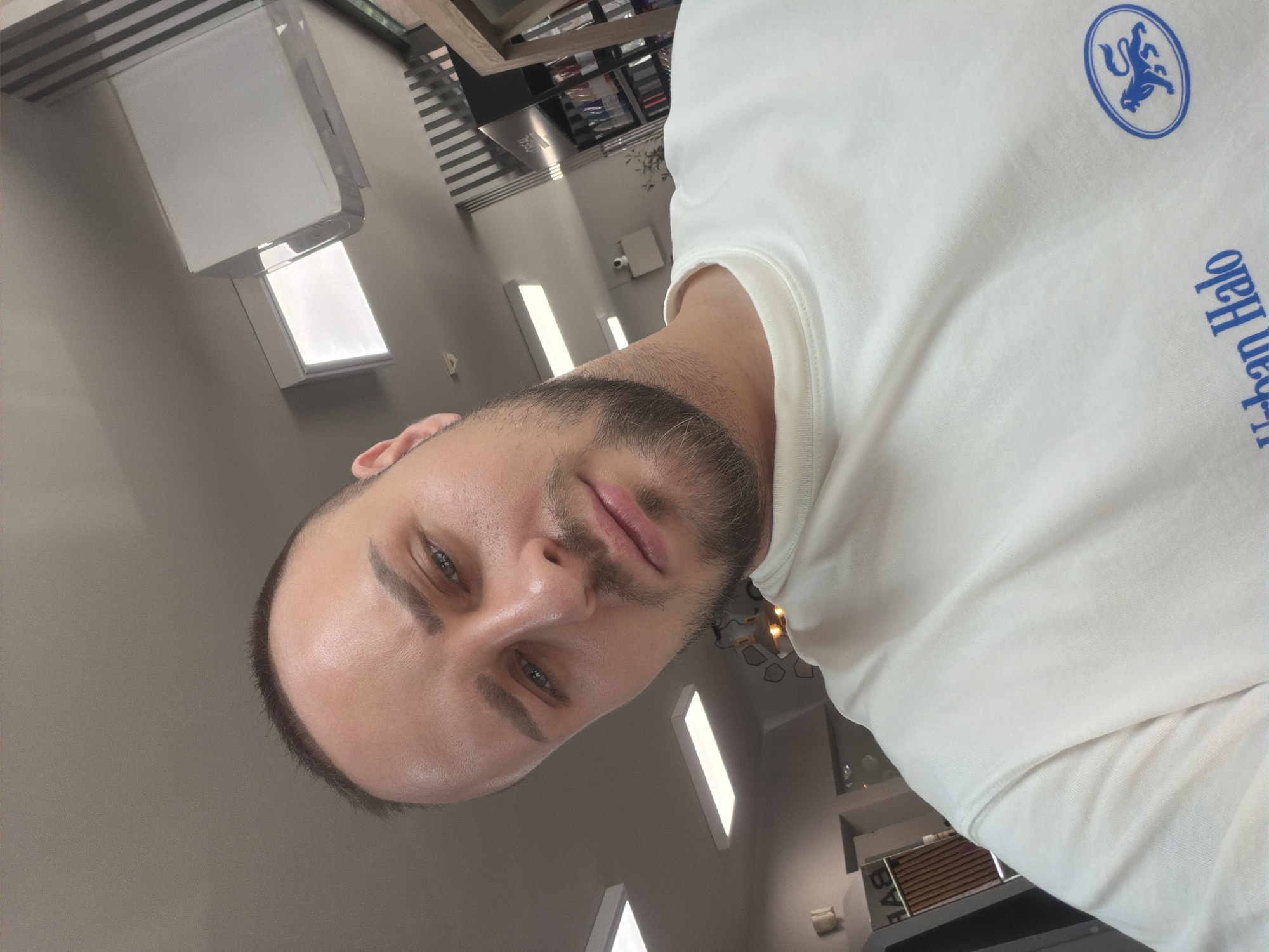 Close-up selfie in Sofia wearing a branded white sweatshirt
