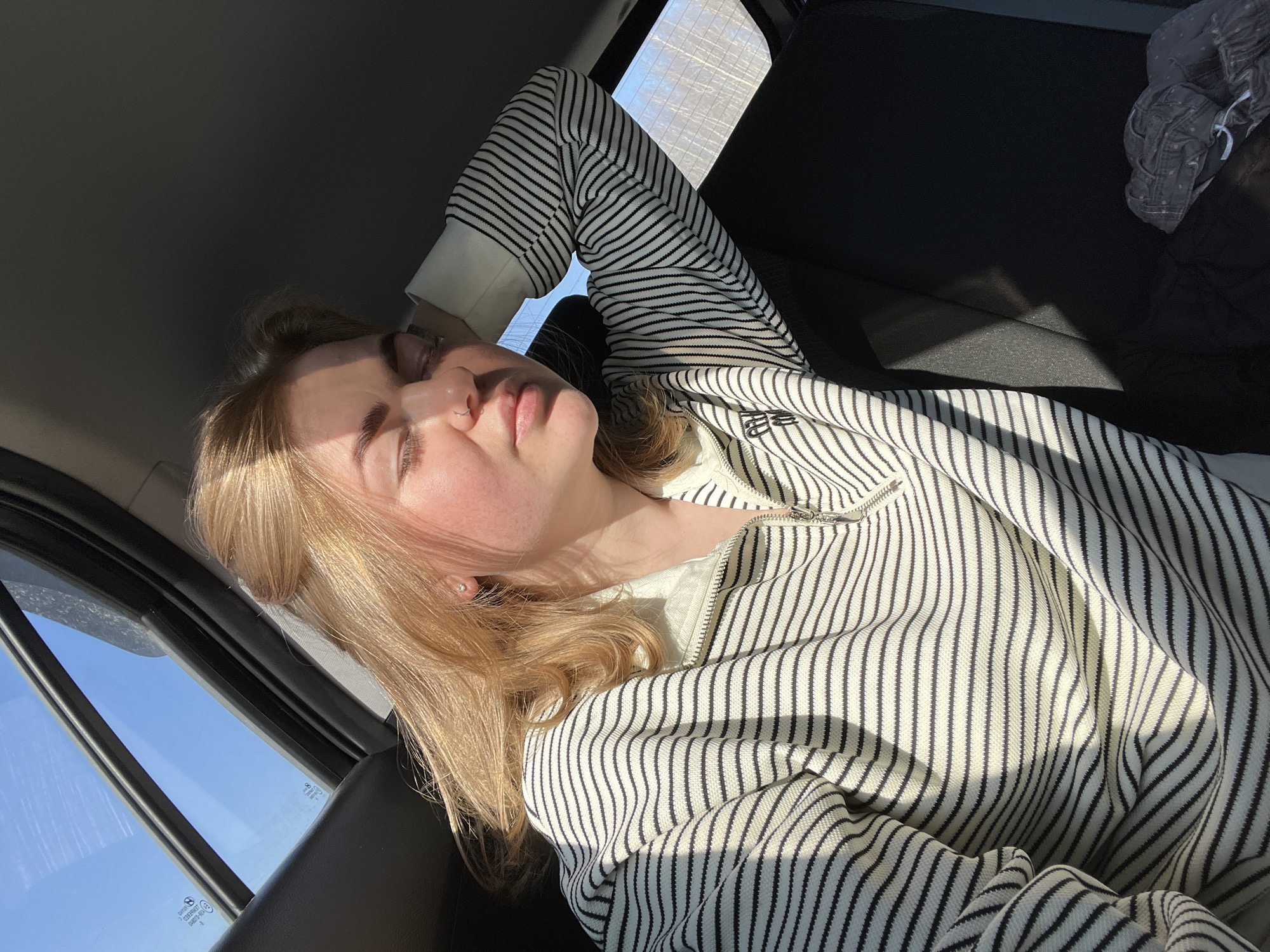 Woman rests in passenger seat during early morning travel