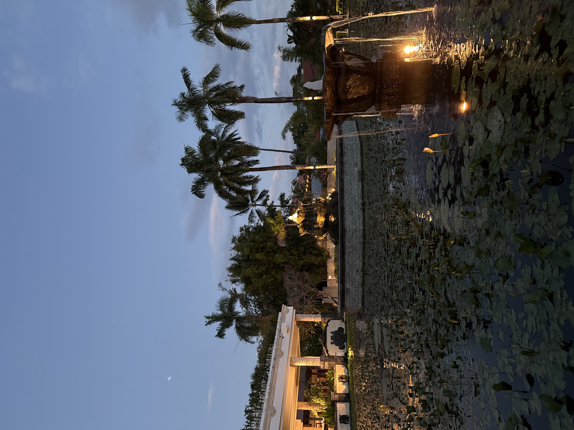 Child plays near water feature in Kuta Selatan