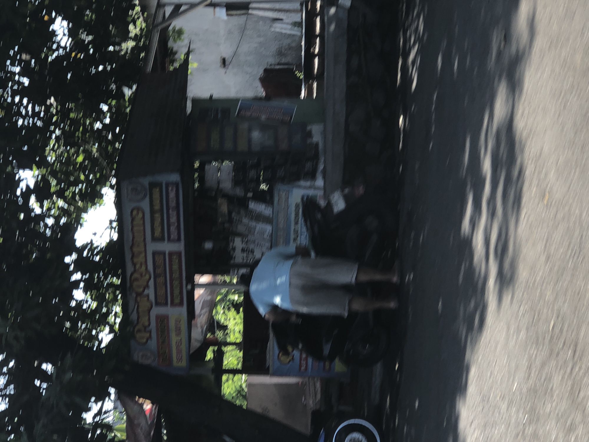 Everyday street life along Indonesian roadside in Buduran