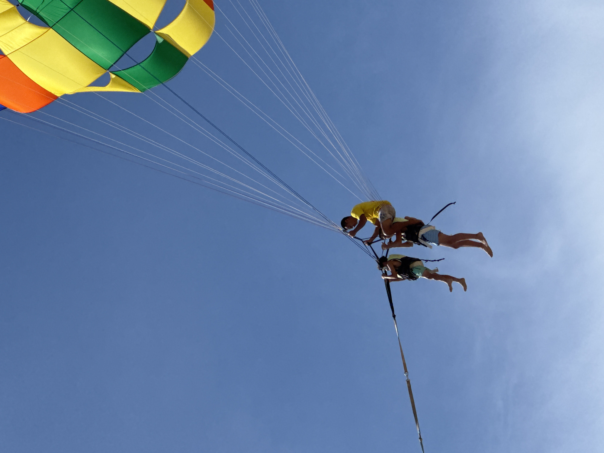 Patong Beach buzzes with parasailing, jet skis, and beachgoers
