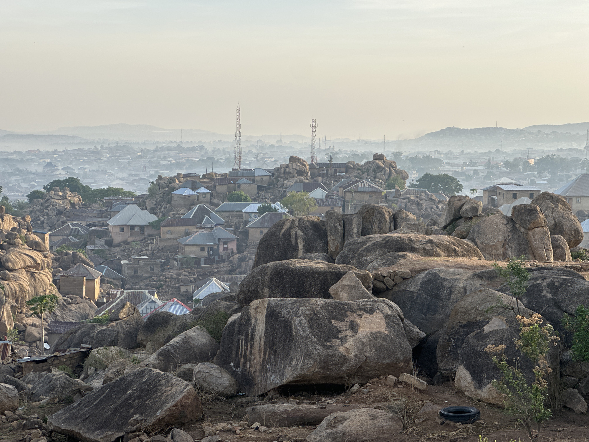 Jos cityscape showcases natural granite formations amid urban development