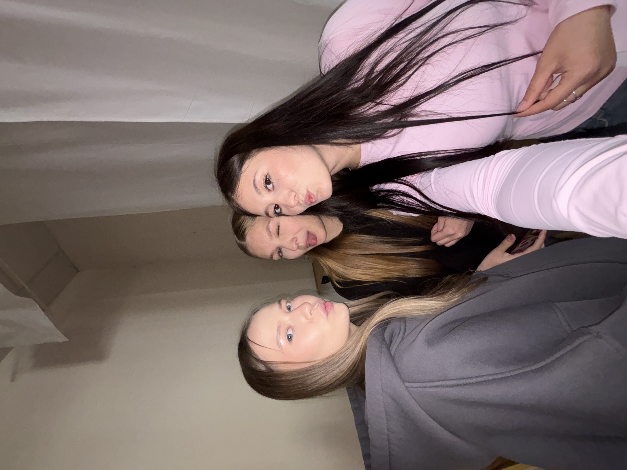 Young women take casual selfies indoors in Chaikovsky, Russia