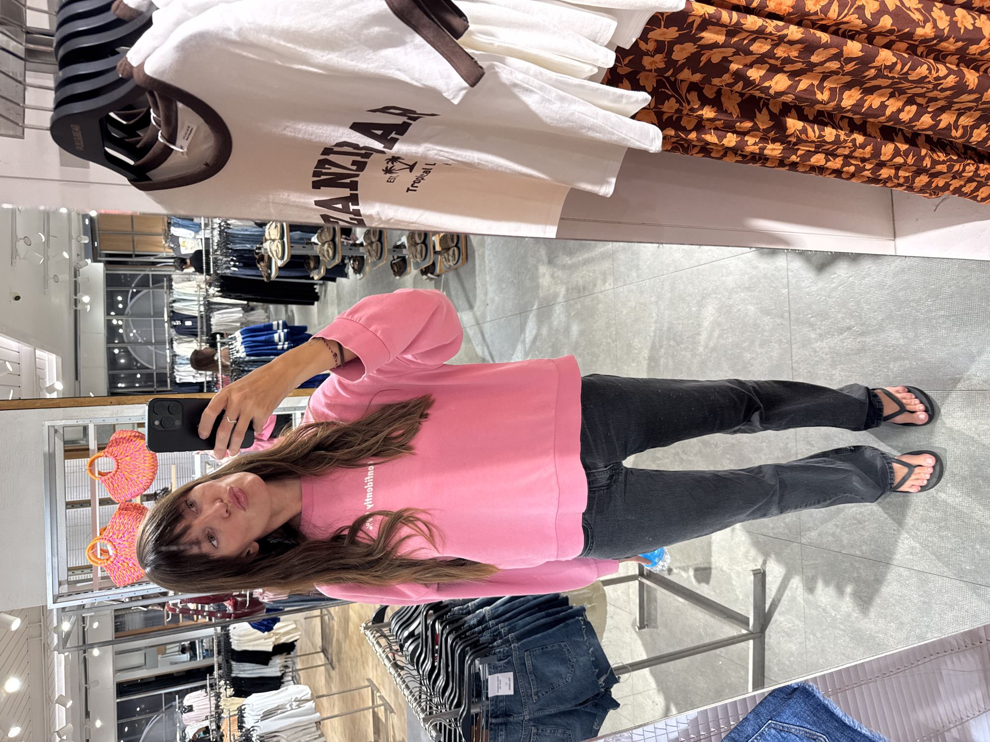 Woman takes selfies in Kuta clothing store
