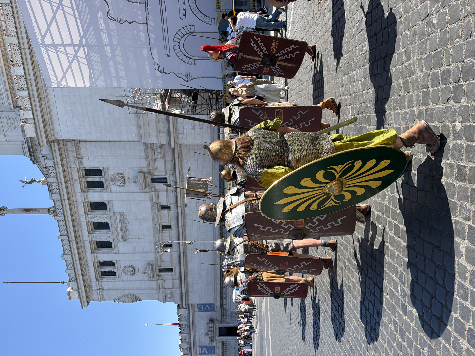 Roman costume performers march through historic Rome piazza
