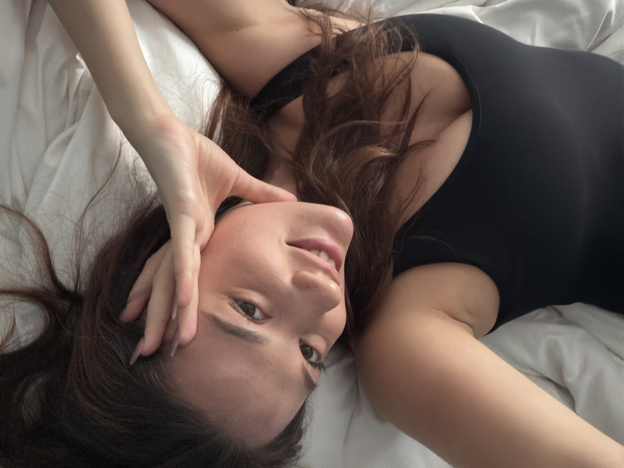 Woman takes bedroom selfies in Athens apartment