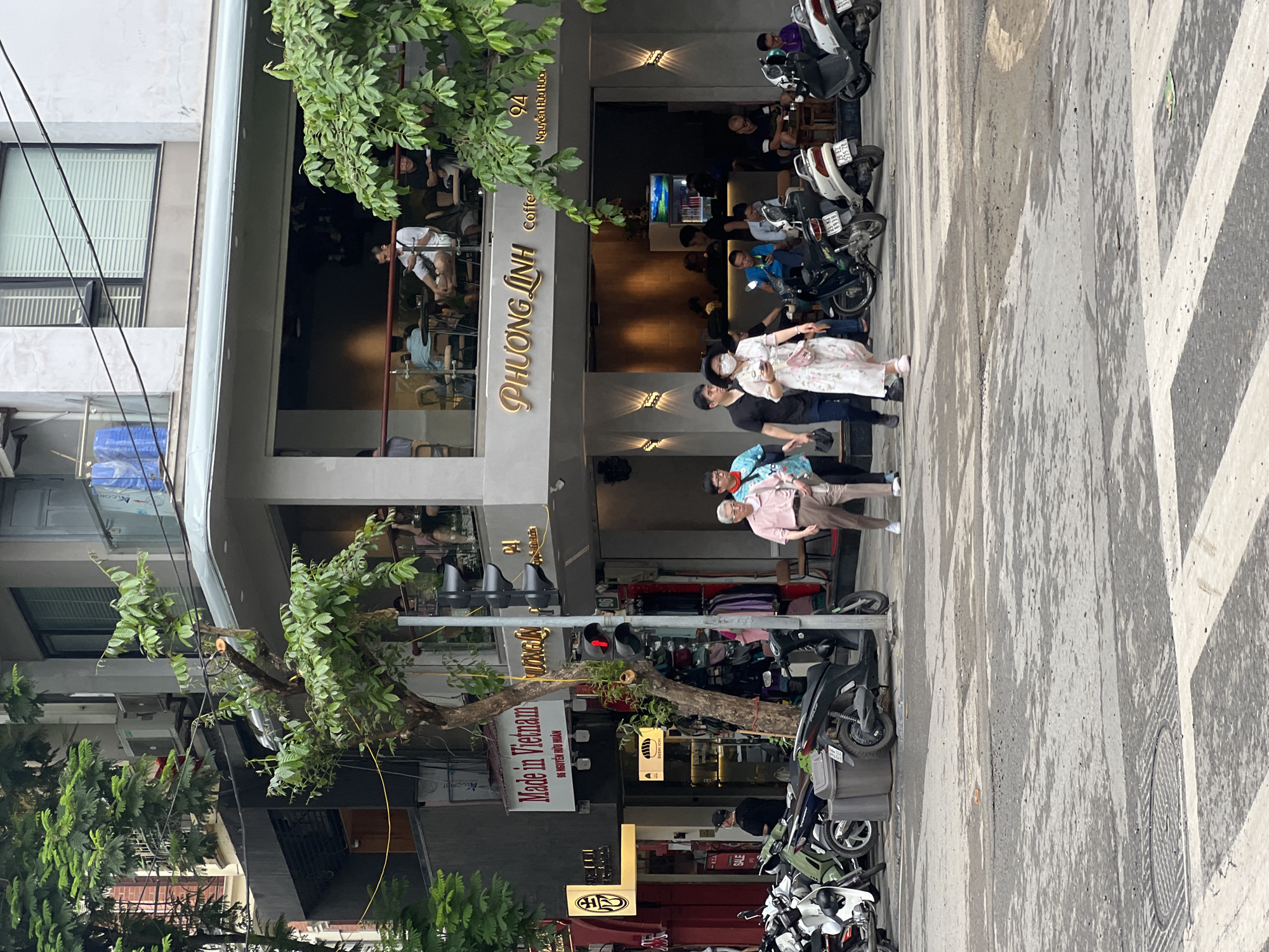 Hanoi street scene: motorcycles, a coffee shop, and wet pavement