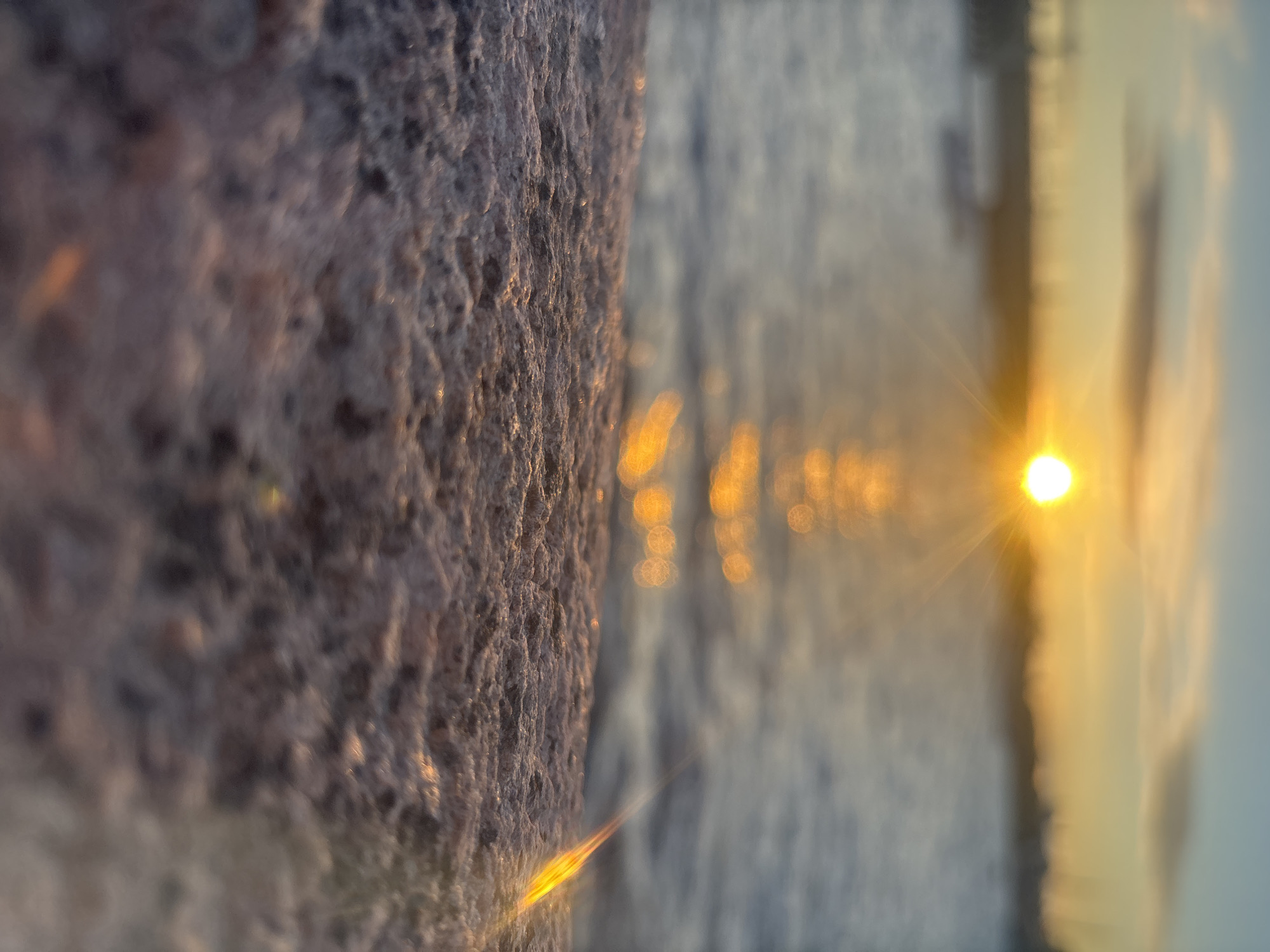 Coastal rock formation documented during sunset at ocean location